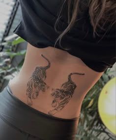 a woman with a tiger tattoo on her stomach