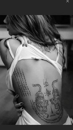 a woman with tattoos on her back