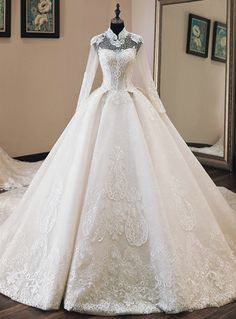 a white wedding dress on display in front of a mirror