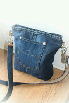 a denim purse sitting on top of a wooden floor