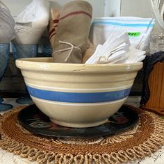 a bowl that is sitting on top of a place mat with some items in it