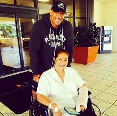 a man in a wheel chair with a woman sitting next to him smiling at the camera