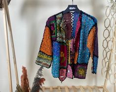 Step into a world of vibrant color and intricate design with our Multicolor Granny Square Crochet Cardigan. This floral, boho hippie-style sweater is the epitome of authentic handmade knitwear, perfect for the eco-conscious fashion lover. Our short Bohemian cardigan is a vintage-inspired hırka, lovingly crafted by skilled artisans. Each crochet jacket is a testament to the art of crochet, made with sustainable fashion knit practices in mind. Yarn 30% Wool, 70% Premium Acrylic Colorful Cardigan L Bohemian Multicolor Outerwear For Spring, Bohemian Long Sleeve Patchwork Sweater, Bohemian Multicolor Outerwear For Fall, Multicolor Bohemian Outerwear For Fall, Colorful Bohemian Long Sleeve Sweater, One Size Long Sleeve Festival Cardigan, Bohemian Patchwork Sweater For Winter, Handmade Bohemian Crochet Long Sleeve Top, Bohemian Multicolor Crochet Top For Fall