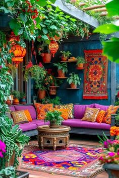 an outdoor living room with plants and rugs