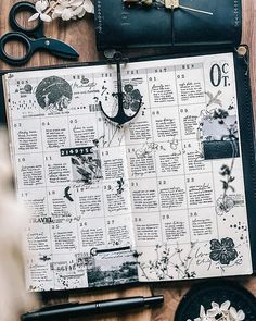 an open planner sitting on top of a wooden table