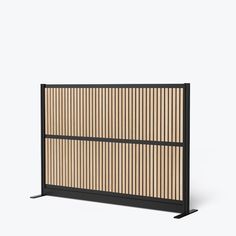 a black and wood screen with vertical slats on the sides, in front of a white background