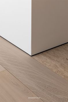 a white box sitting on top of a hard wood floor next to a wooden floor