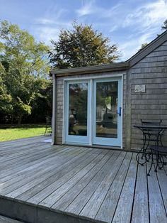 a deck with table and chairs on it