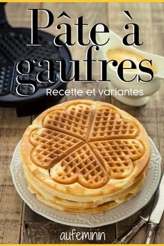 a plate topped with waffles on top of a wooden table