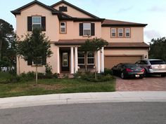 two cars parked in front of a house