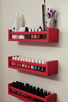 two red shelves with different types of nail polish on them