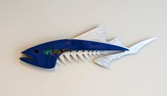 a blue and white fish shaped comb on a table