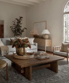 a living room filled with furniture and a large window