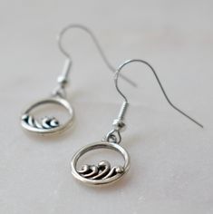 These adorable sterling silver earrings are just too cute to pass up. Featuring tiny, abstract waves, these oxidized sterling silver wave earrings are simple, fun and a little bit artsy. The drop is about 3/4 of an inch and the charm itself is just under 1/2 of an inch.  Sterling silver earring hooks are also used to ensure no discoloration to your ear. Made for you in Washington. Wave Earrings, Wave Jewelry, Ocean Earrings, Personalized Leather Bracelet, Abstract Waves, Metal Letters, Blue Pearl, Cord Bracelets, Oxidized Sterling Silver