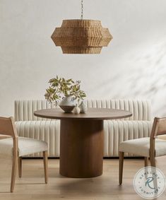 a dining room table with chairs and a basket hanging from the ceiling