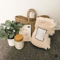 a basket, potted plant and greeting card sitting on the floor next to it