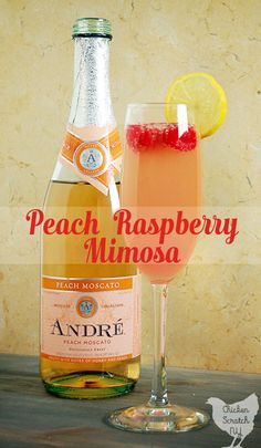 a bottle of peach raspberry mimosa next to a glass filled with liquid