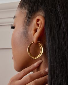 The Stella Hoop Earrings are bold chunky hoops with a modern, freeform shape and sharp edges that create a unique look. Despite their volume, they remain lightweight and comfortable thanks to our exclusive Italian electroforming technology. Crafted from sterling silver and plated with 18K yellow gold or white gold, each pair is hand-polished to perfection for a luxurious finish. Perfect as a gift for her, gift for mom, or best friend gift, these hoop earrings make a stylish statement. Closure: H Earring Sale, Unique Earrings, Shop Earrings, Jewelry Pieces, Metallic Silver, Gold Earrings, Gifts For Mom, 18k Gold, Hoop Earrings