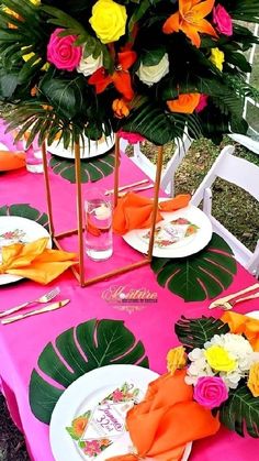 the table is set with colorful flowers and plates