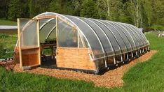 a small greenhouse in the middle of a field