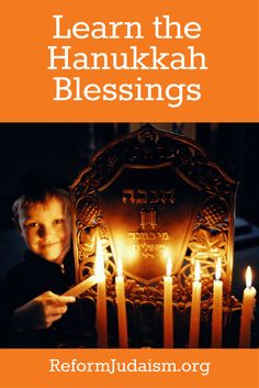 a young boy holding a lit menorah with the words learn the hanukkah blessing