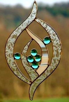 a stained glass sun catcher hanging from a window