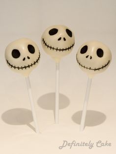 three lollipops with faces on them sitting in the shape of jack skewers