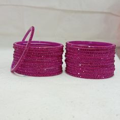 Bangles Name - Penali Burj Khalifa   Color - Rani   Size - 2.2/2.4/2.6/2.8   Weight - 60 grams   Piece - 12   Stone Color- Rani  100% Glass Bangles & Handmade Product. You can wear it while going to a wedding by matching it with your clothes. You can also gift it to someone. You can also wear it in an engagement. It looks very beautiful in your hands. about shipping  Ships within 1 to 3 business days after payment is received  We ship orders every day except Sundays and holidays  When your order Plastic Round Jewelry For Parties, Round Plastic Party Jewelry, Plastic Bangle Jewelry For Party, Pink Plastic Bangle Jewelry, Color Bracelets, 12 Stones, Glass Bangles, Fancy Jewellery Designs, Bangles For Women