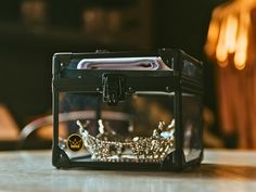 a glass box with a crown on it sitting on a table