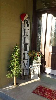 a sign that says believe on the front porch