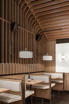 the interior of a restaurant with wooden walls and booths