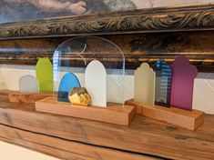 a group of wooden pieces sitting on top of a mantle