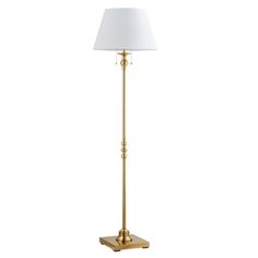 a gold floor lamp with a white shade on the base and a square light bulb