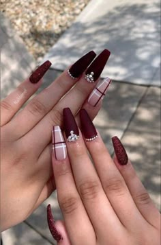 two hands with red and white nail polish on them