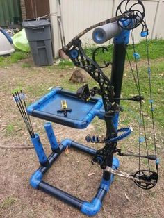 an archery set up on the ground in front of a building with lots of wires attached to it