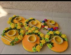 there are six decorated cakes with flowers on the top one is yellow and the other is orange