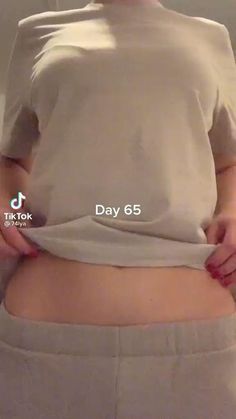 a woman is showing off her stomach with the words'day 65'on it