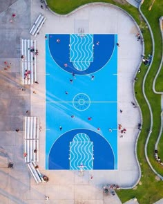 an overhead view of a swimming pool with people standing around and looking at the water