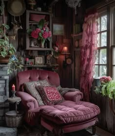 a pink chaise lounge chair sitting in front of a window