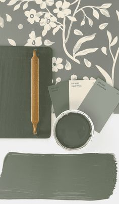 the paint is being used to create an elegant wallpaper with grey and white flowers