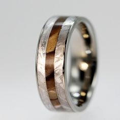 a wedding ring with two wood inlays