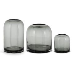 three glass vases sitting next to each other