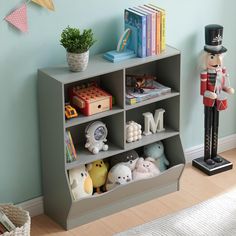 a toy soldier stands in front of a bookcase filled with toys and other items