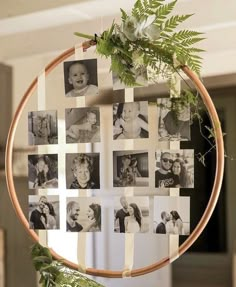 a wooden hoop with photos hanging from it's sides and greenery in the middle