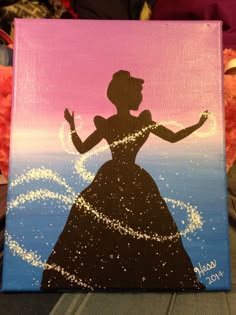 the silhouette of a woman in a dress is painted on a canvas