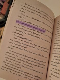 an open book with some writing on it's page and the title in purple