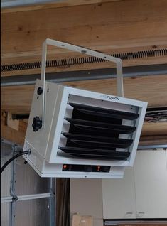 a white air conditioner hanging from the ceiling