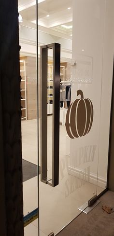 a glass door with a pumpkin decal on the front and side panels in an office building