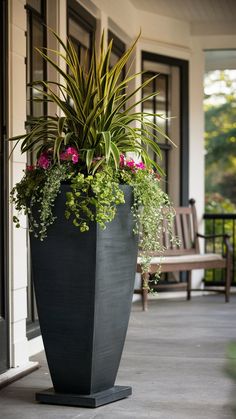 a large planter with plants in it on the front porch