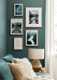 a living room with blue walls and pictures on the wall